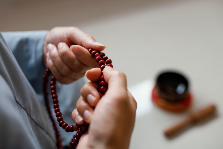 high-angle-woman-holding-beads-meditating_23-2148847546